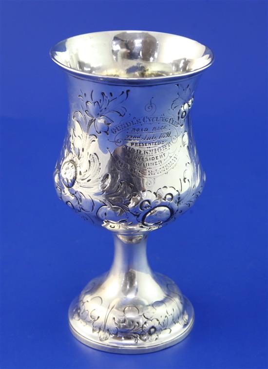 A Victorian repousse silver goblet with presentation inscription relating to the Oundle Cycling Club, 3.5 oz.